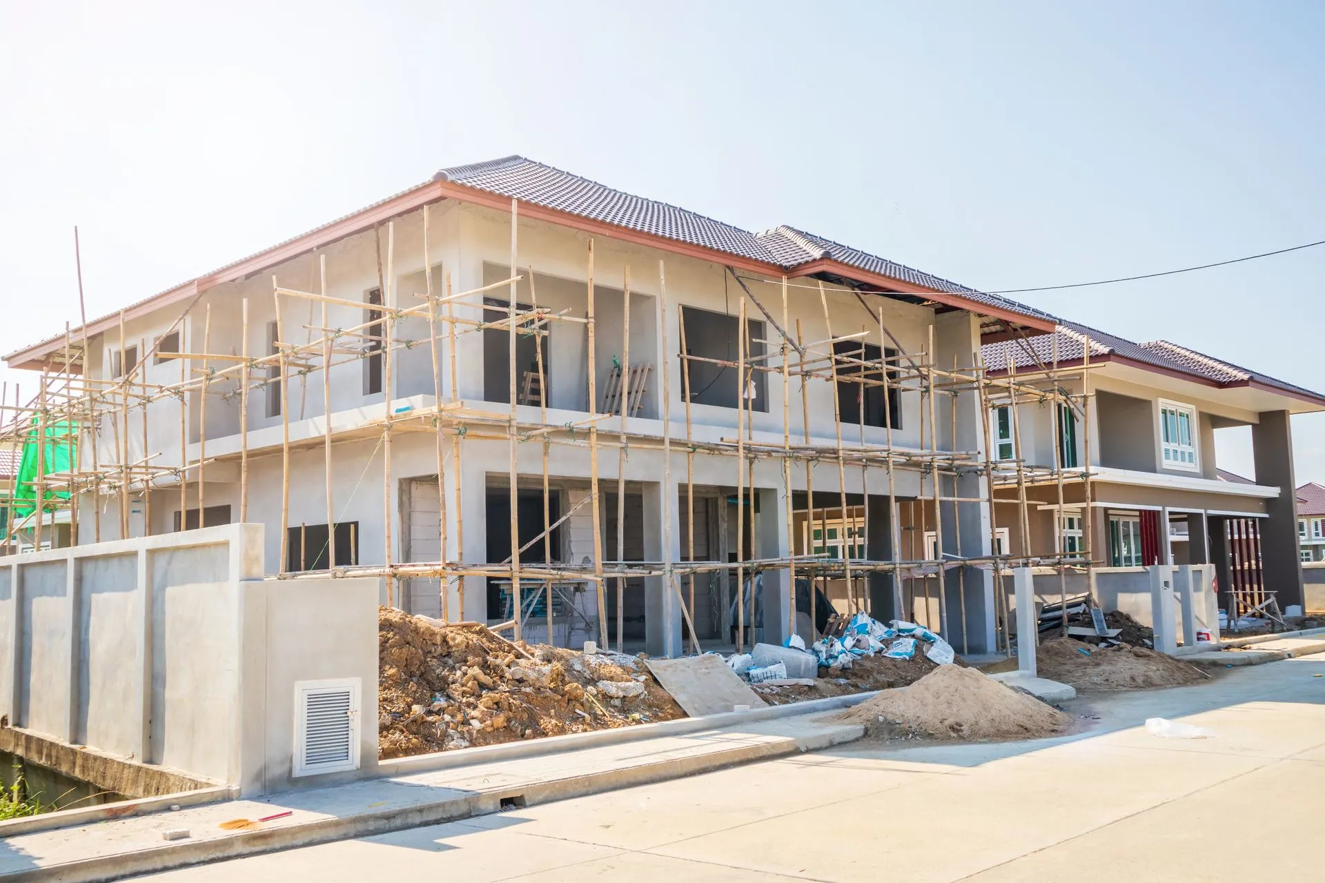 A large house is being built in a residential area.