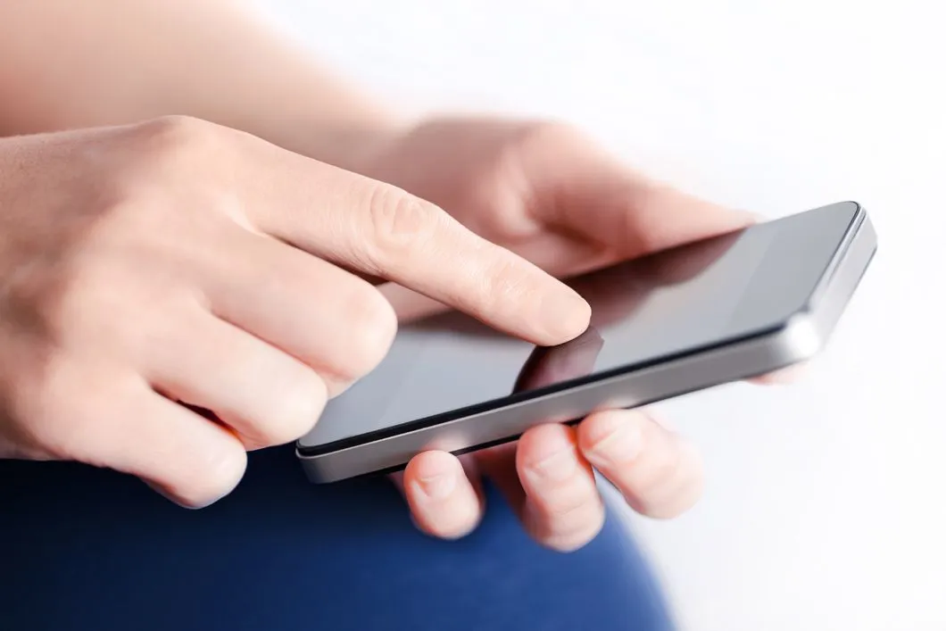 A close up of a person using a cell phone